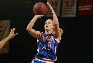 Picture of Sarah Kustok playing basketball while in high school