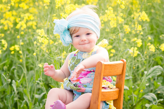 Family session including one-year cake smash in an Oklahoma canola field by Michelle Valantine Photography.