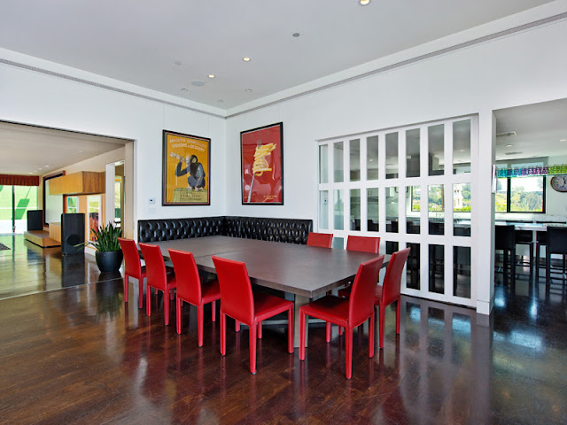 Photo of dining room interiors at the Bel Air modern residence with red chairs