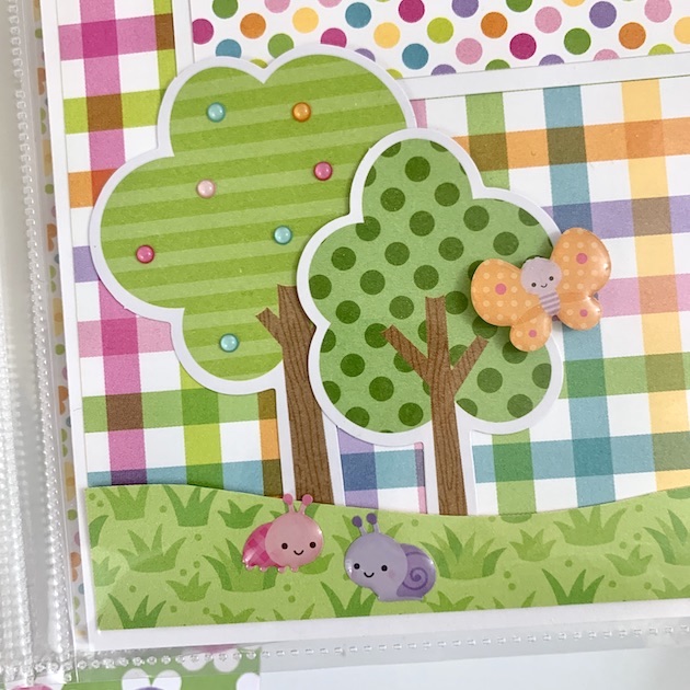 8x8 Spring scrapbook pages with a cute enamel butterfly, ladybug, snail, and trees with little colorful dots