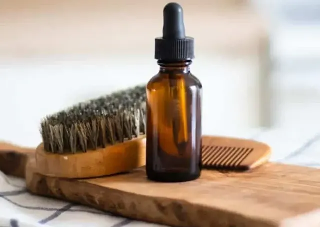 A bottle of non commercial beard oil and combs