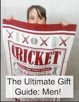 Boy holding up beach towel with Cricket references on. 