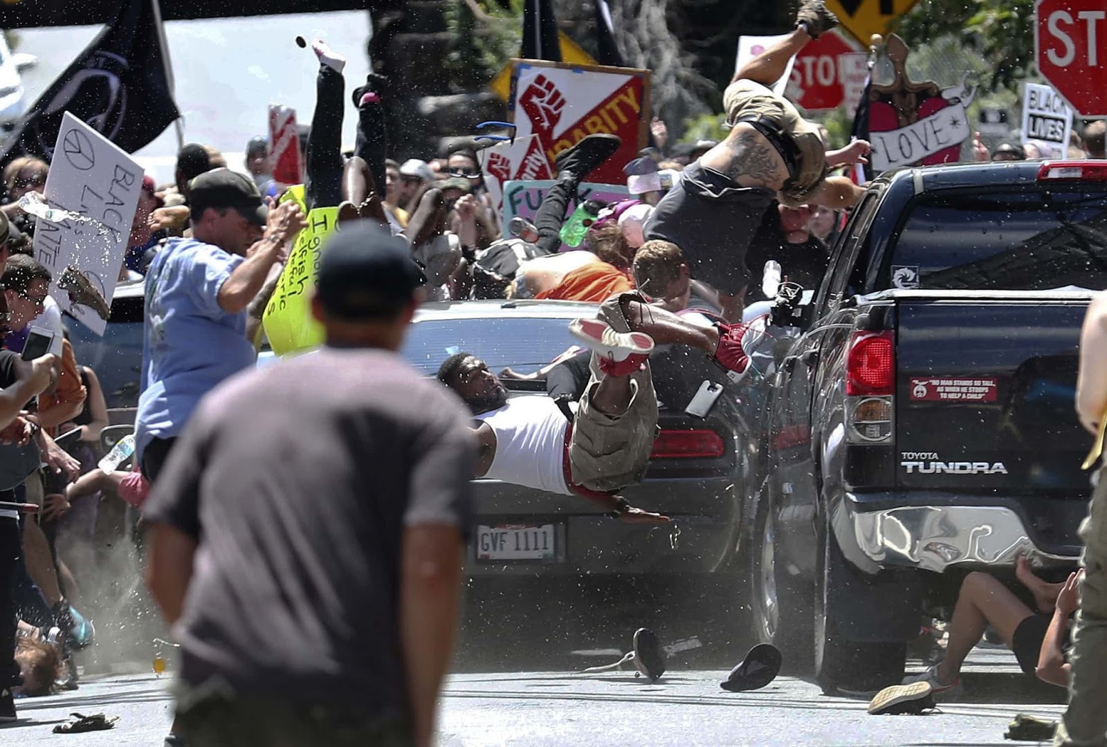 25 Of The Most Intriguing Pictures Of 2017 - A man drives into anti-far-right protesters