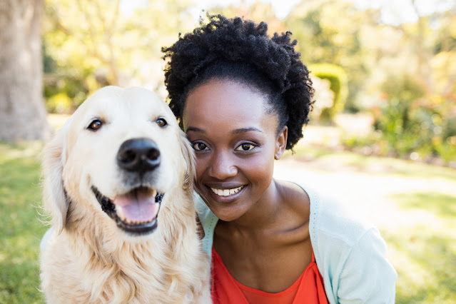 Diversity initiatives in animal behavior & dog training. Photo shows young black woman with happy Golden Retriever