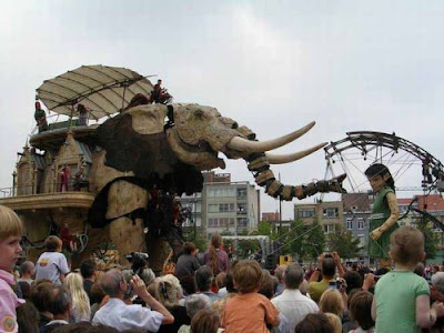 giant mechanical elephant and giant girl with lollypop