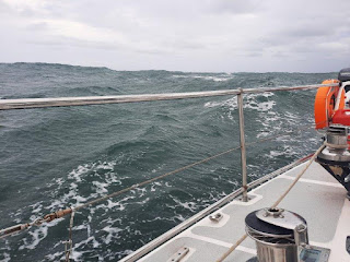 Grey water and skies from stern of sailing yacht