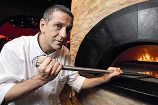 Famous chef Giorgio Locatelli feeds the pizza oven at the Atlantis hotel in Dubai.
