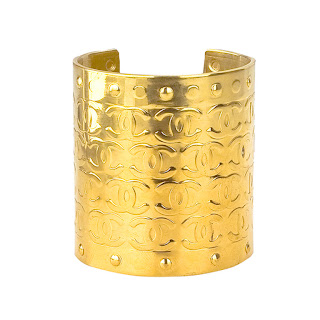 Vintage 1990's large gold Chanel cuff bracelet with engraved "CC" logo pattern.