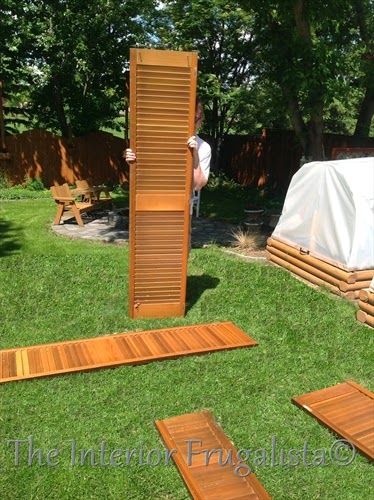 A budget-friendly DIY Privacy Fence or Garden Screen idea made with salvaged and repurposed wooden louvered bi-fold doors, a unique outdoor fence idea.