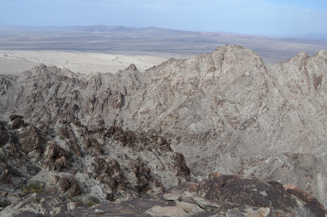 jagged ridge across the view, and then more flat, but with bumps in the distance