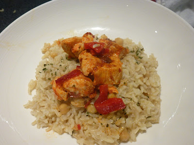 Moroccan chicken with rice in a white bowl