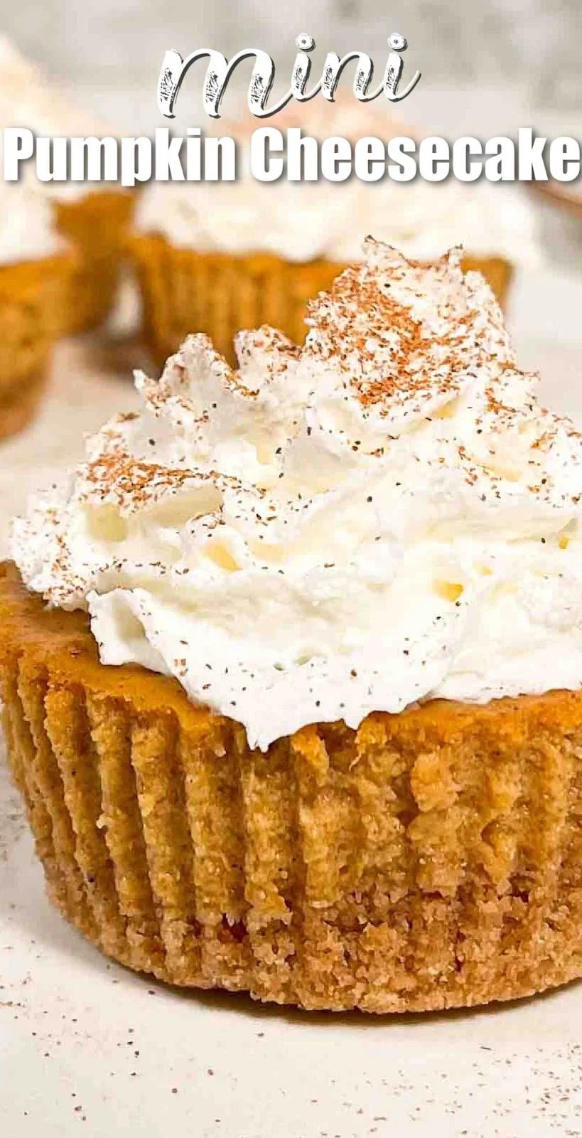 A side shot of a Mini Pumpkin Cheesecakes. White text at the top of photo Mini Pumpkin Cheesecake.