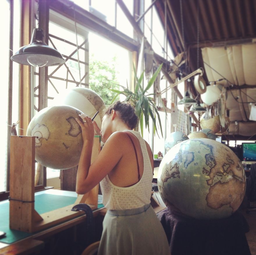 Varnishing a finished globe that will then go onto a handcrafted wooden base - One Of The World’s Last Remaining Globe-Makers That Use The Ancient Art Of Making Globes By Hand