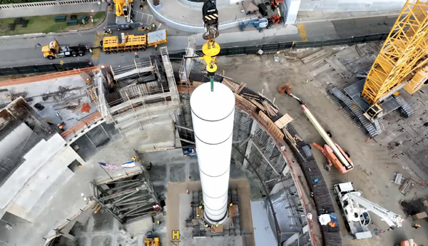 The first of two solid rocket motors that will form the backbone of Endeavour's completed space shuttle stack is now secured atop its aft skirt inside the Samuel Oschin Air and Space Center's construction site in Los Angeles...on November 7, 2023.