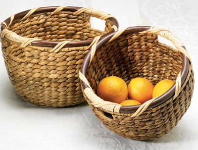 2 round water hyacinth baskets; one has fruit inside