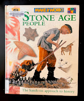 Cover of Stone Age People - it shows a picture of a modern boy dressed as a stone age person, and various stone age items around him.