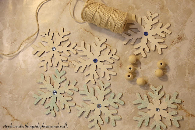 painted wooden snowflakes, beads, and twine.