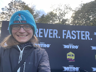 Me smiling in front of the podium for the half marathon.