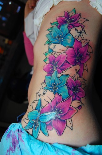 Flower tats can also be added to other tattoo designs and change the entire