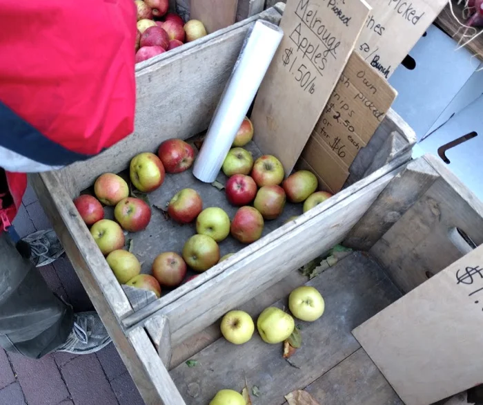 The very last apples in wooden crates