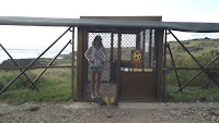 Double gate & fence at Kaena Point Coastal Reserve, Oahu, Hawaii. Note the device outside to wipe one’s shoe soles.