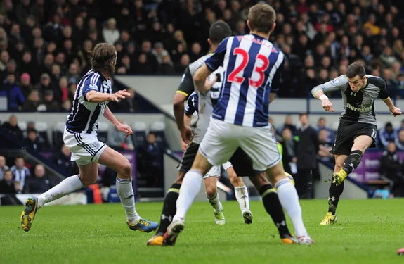 Tottenham player Gareth Bale shoots to score the winner against West Bromwich Albion