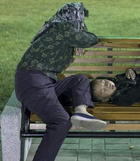 mother and child fell asleep on a park bench