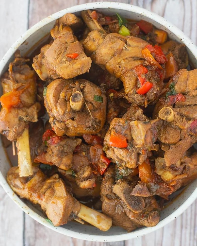 A bowl of Trinidad style stew chicken, cooked down and ready to serve.