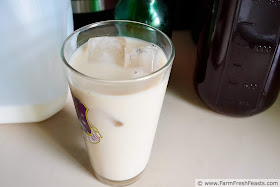 image of a glass of iced chai with a bottle of chai concentrate, an Instant Pot, a bottle of simple syrup, and a jug of milk.