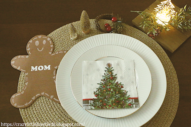 Holiday table setting displayed with holiday decor