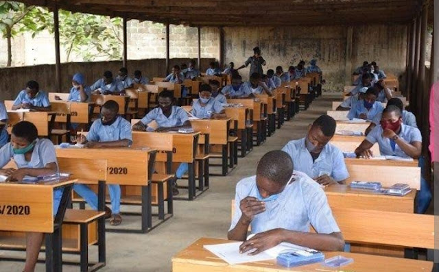 Alt: = "students seating in a exams hall"