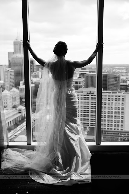 Bride looking out window in downtown Indianapolis