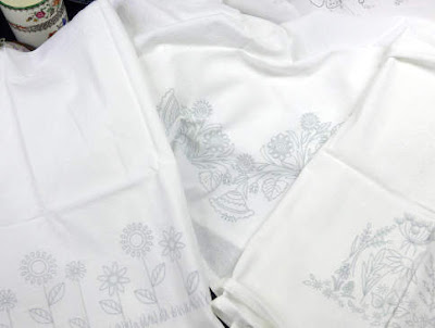 Three flour sack towels designed by Mary Corbet ready to stitch