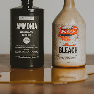 Two bottles, one labeled "Ammonia" and the other labeled "Bleach."