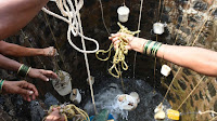 Villagers throw containers into a well to collect their daily supply of potable water after a tanker made its daily delivery in Shahapur, India, on May 13. India is in the midst of a drought. (Credit: Indranil Mukherjee/AFP/Getty Images) Click to Enlarge.