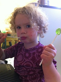 Young girl enjoying Black Pepper Melon lollipops