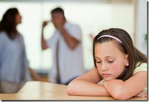Sad girl with her fighting parents behind her