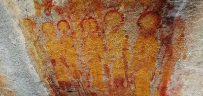 Ancient cave art depicting Aliens and a UFO in India.