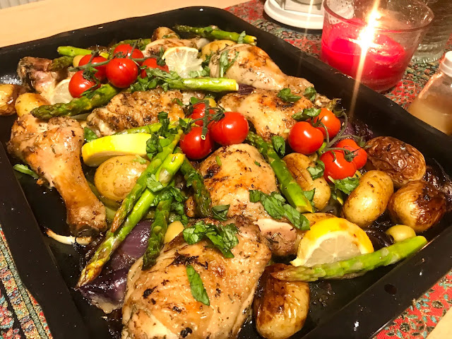 Greek chicken tray bake with asparagus, tomatoes, potatoes and red onion