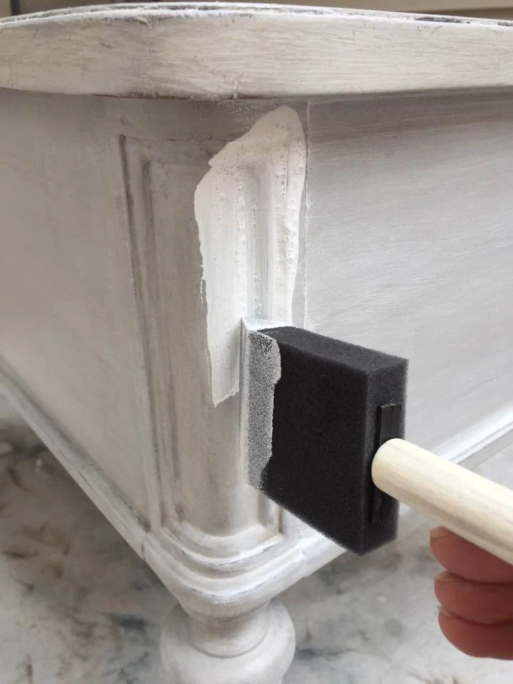 Applying white glaze over the painted finish.