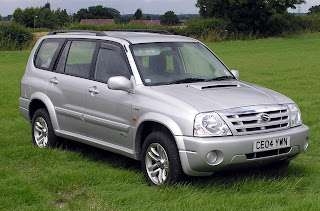 Suzuki Grand Vitara on green grass 