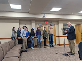 Town Council Chair Tom Mercer with proclamation recognizing the FHS student for their work on the plastic bag prohibition
