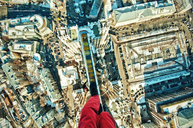 Man walking on the narrow steel beam high in the air