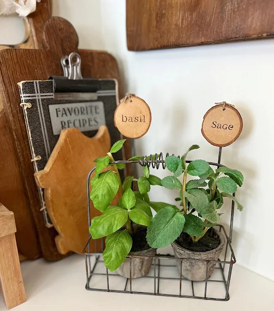 Photo of 2 DIY wood slice herb plant markers.