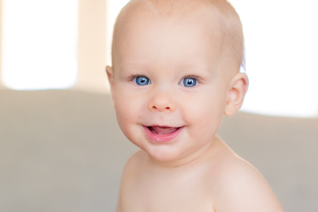 At 9-months old, he loves peek-a-boo and playful noises.   Taken as part of Baby's First Year Package, this 9-month mini session offers 3 digital images in a single pose.