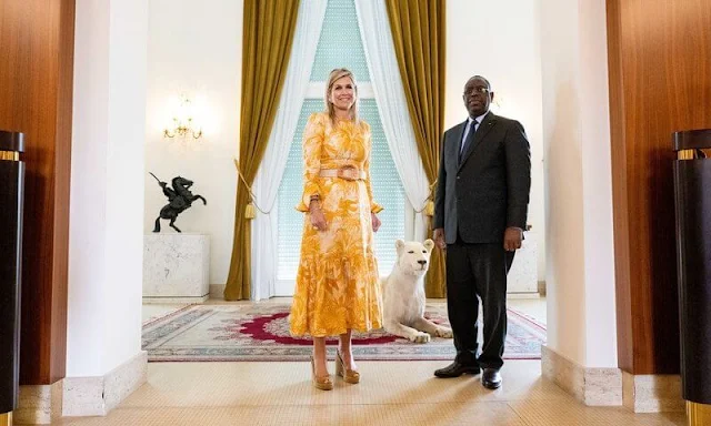 Queen Maxima wore a saffron Mae belted ruffled printed linen midi dress by Zimmermann. Princess Catharina Amalia tiara