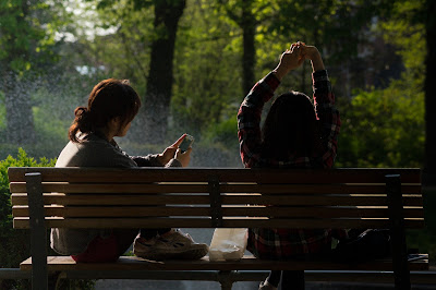 two girls sat on a bench