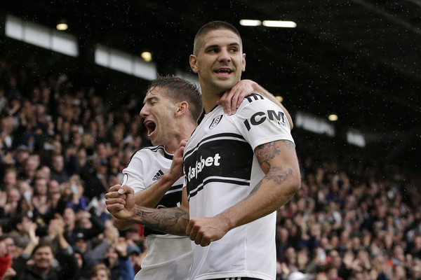 Aleksandar Mitrovic of Fulham celebrates with teammate Luciano Vietto after scoring his team's second goal during the Premier League match between Fulham FC and Burnley FC at Craven Cottage on August 26, 2018 in London, United Kingdom.