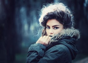  young woman holding a beautiful umbrella in the rain