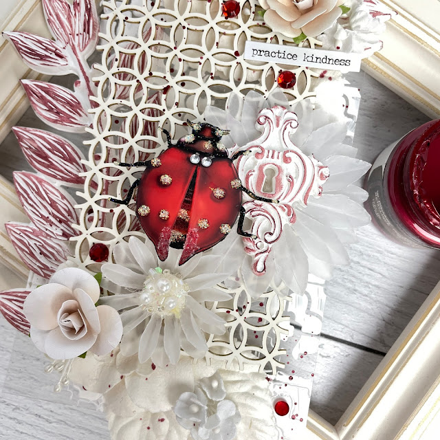 ladybug acetate gift tag made with Reneabouquets chipboard and glass wing lady bug; Prima acrylic paint, resin moulds, wax, paper flower; Pinkfresh red crystals; Tim Holtz velvet trim and crinkle ribbon.
